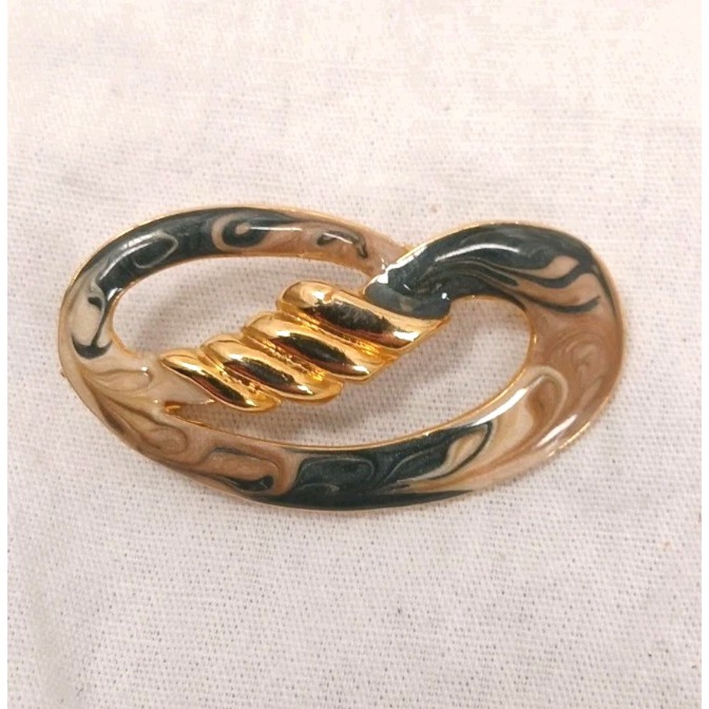 Circular Brooch, black, beige and whites swirled with gold accents, 2 inches